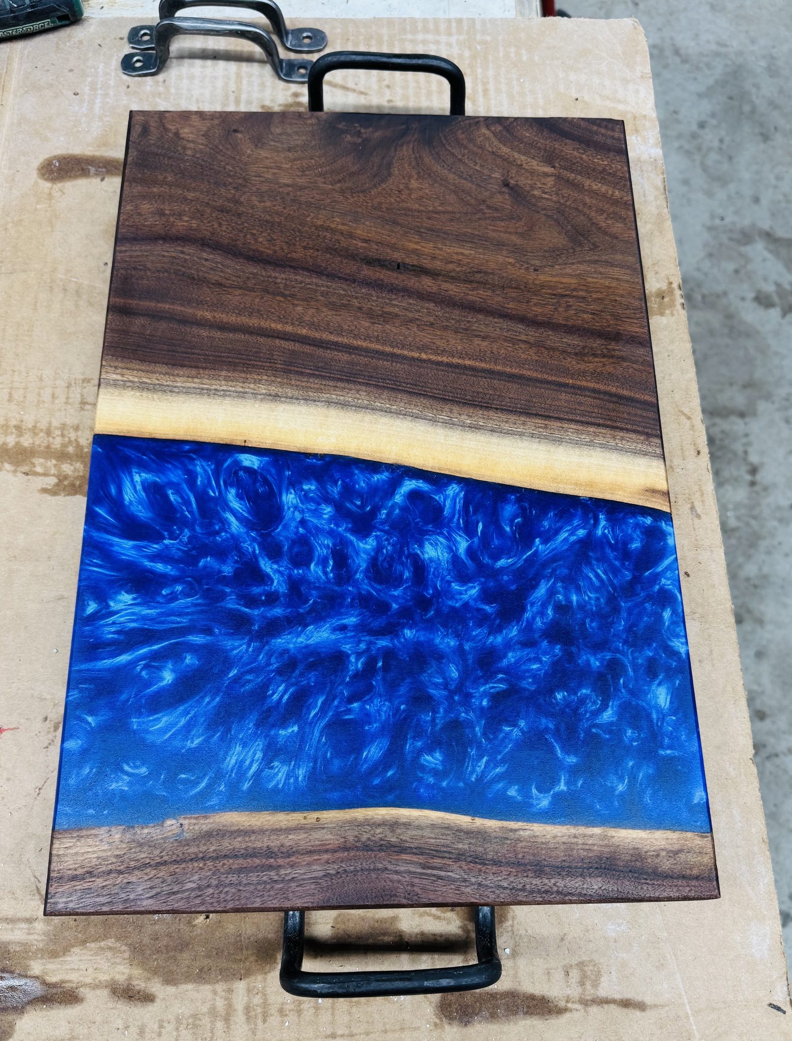 Serving board with blue epoxy and handle