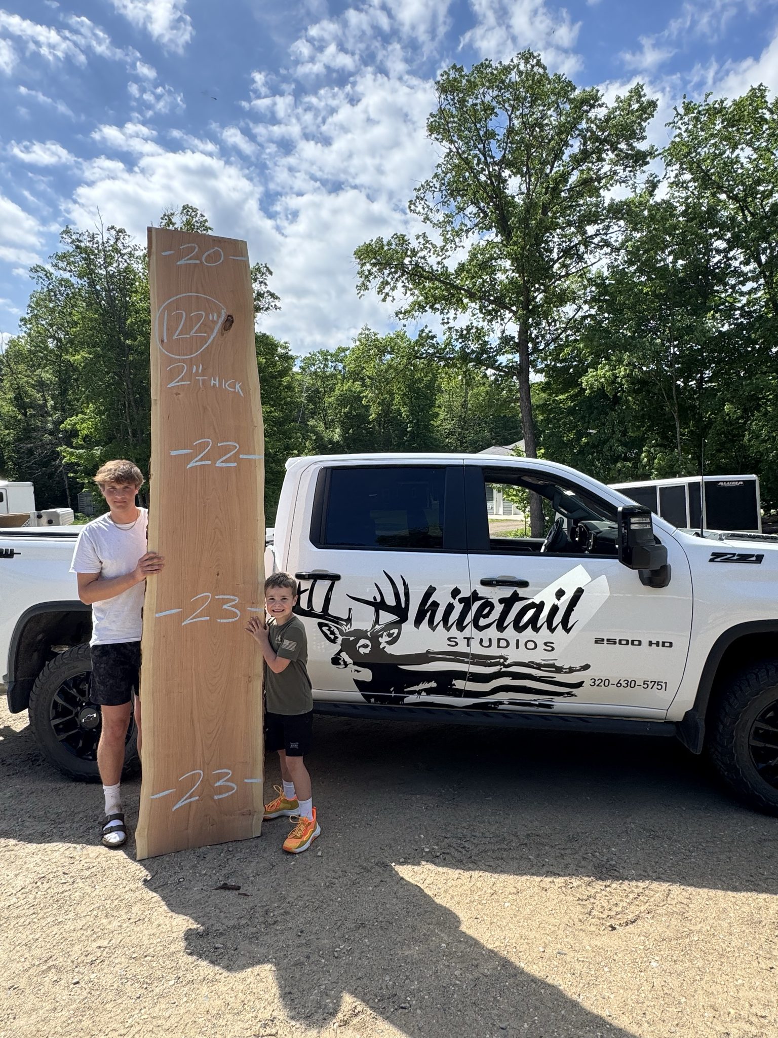Large live edge slab beside the Whitetail Studios truck