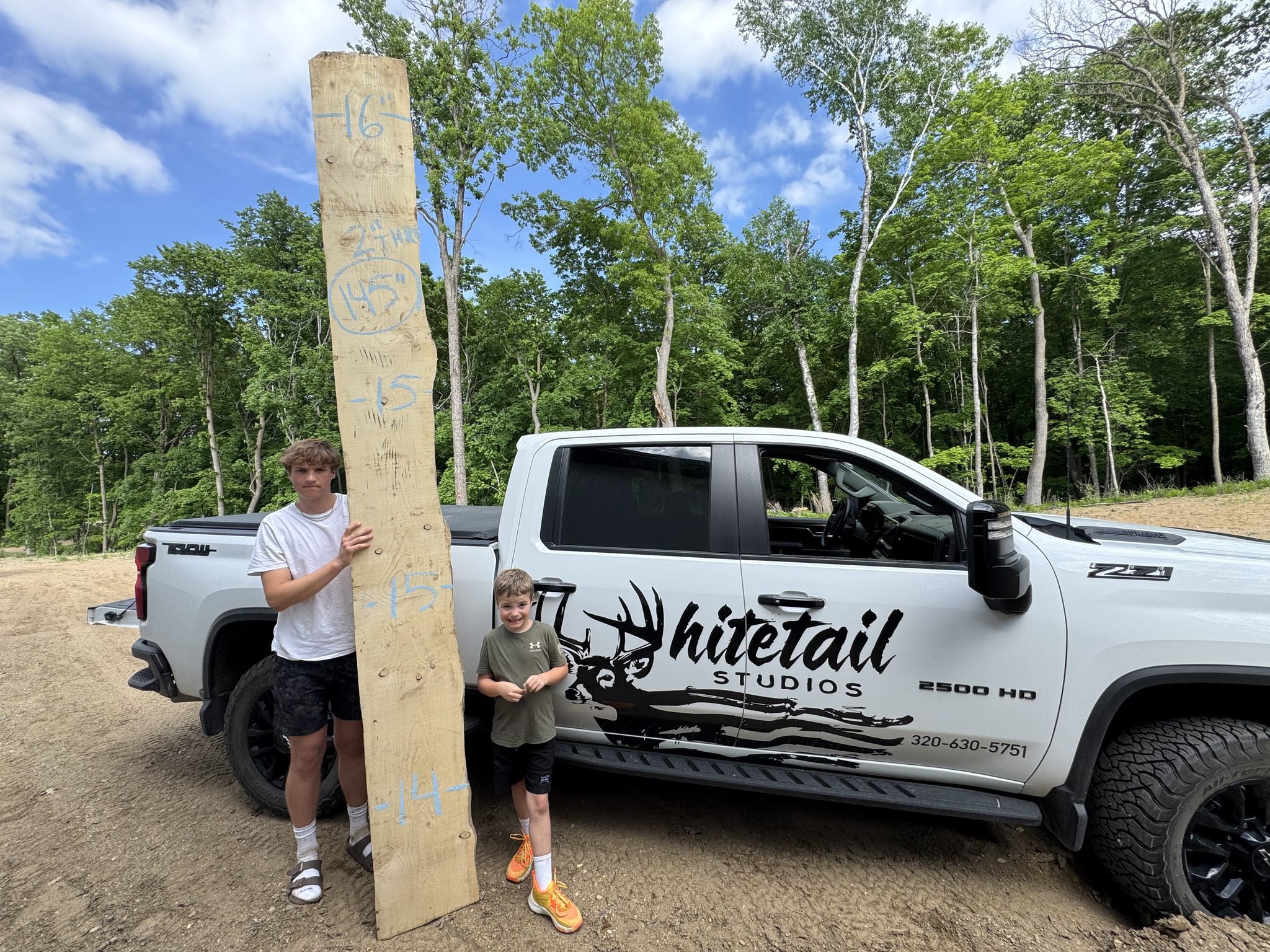 Tall live edge slab beside the Whitetail Studios truck