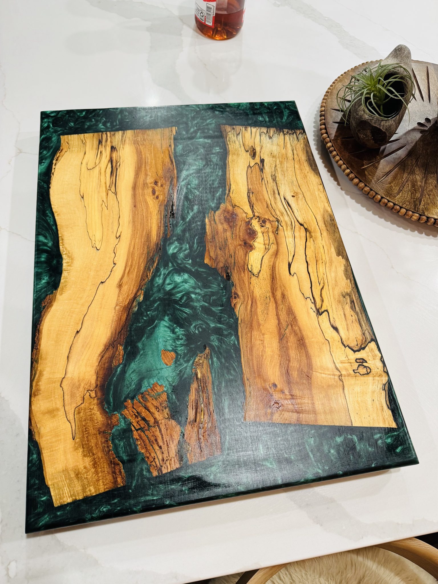 Figured wood slab with green epoxy