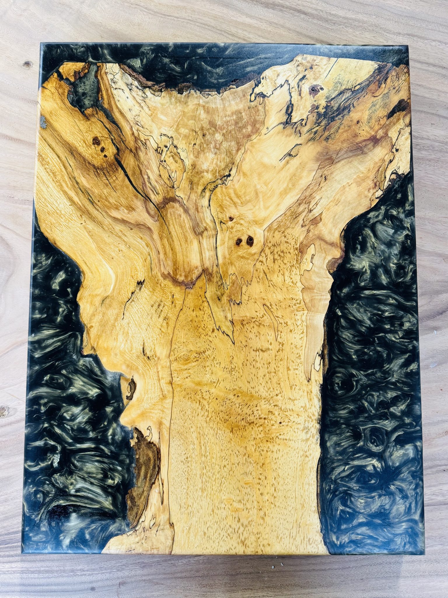 Figured maple with blue epoxy river