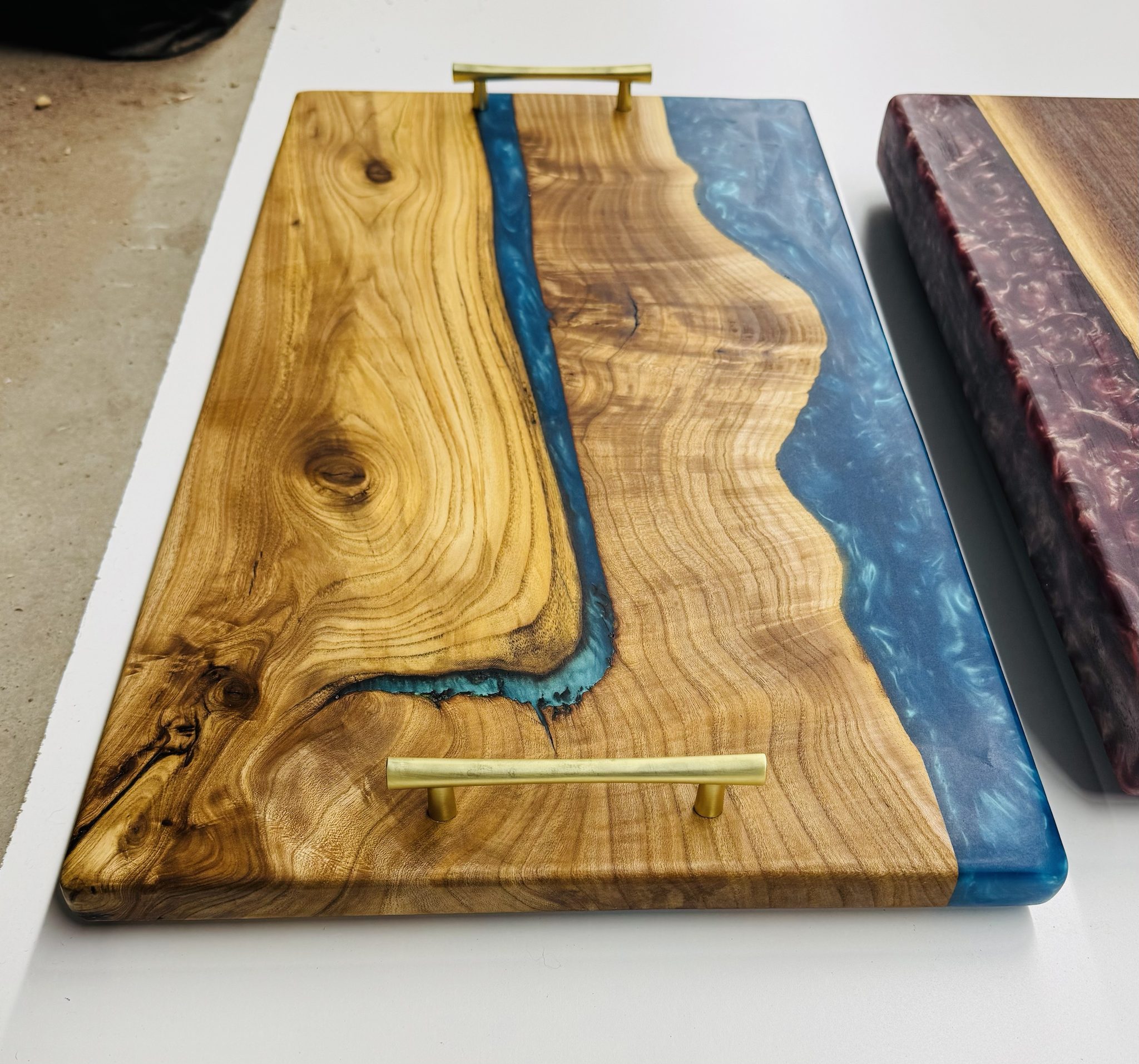 Serving board with blue epoxy and brass handle