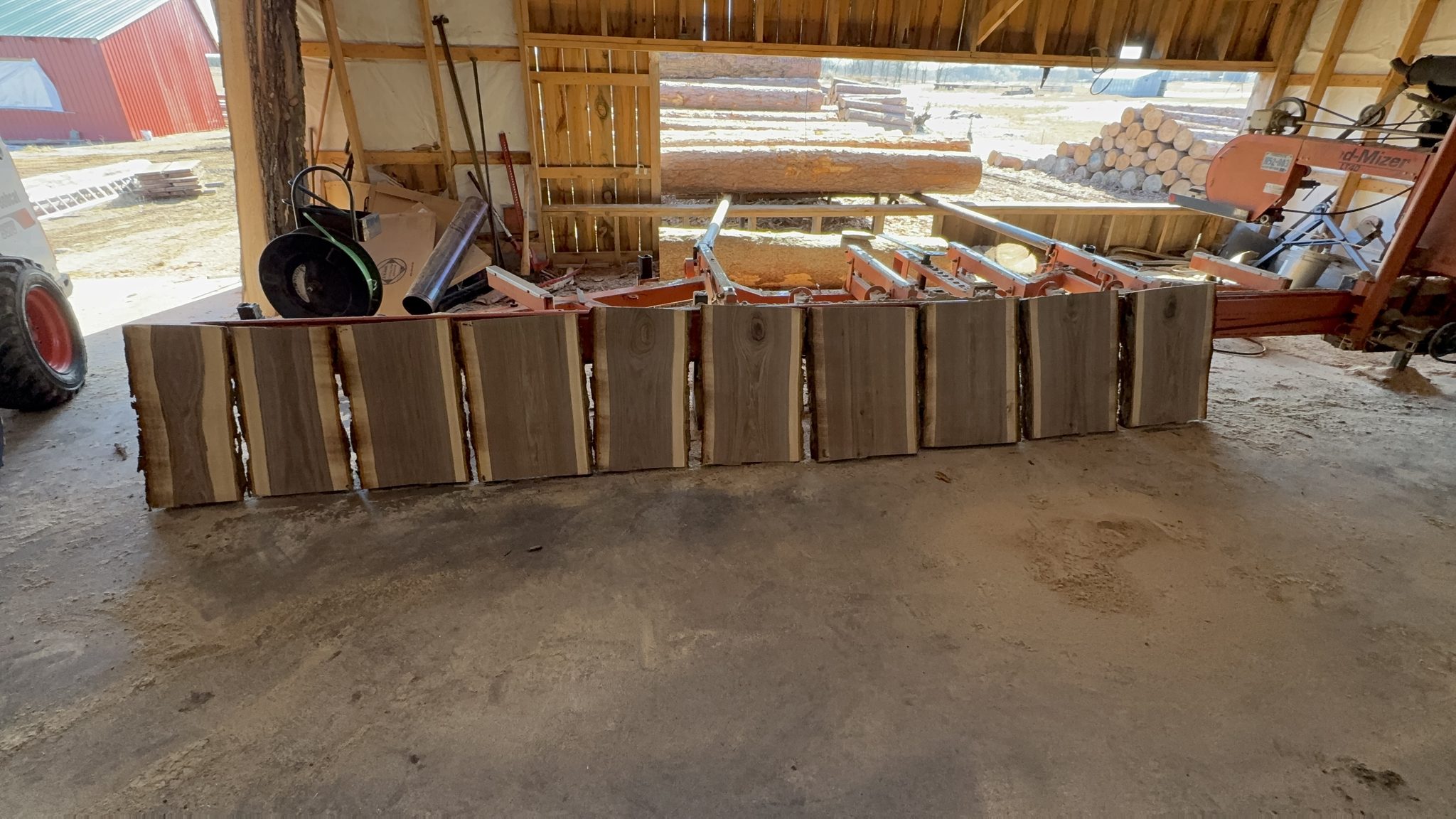Raw wood slab collection in barn