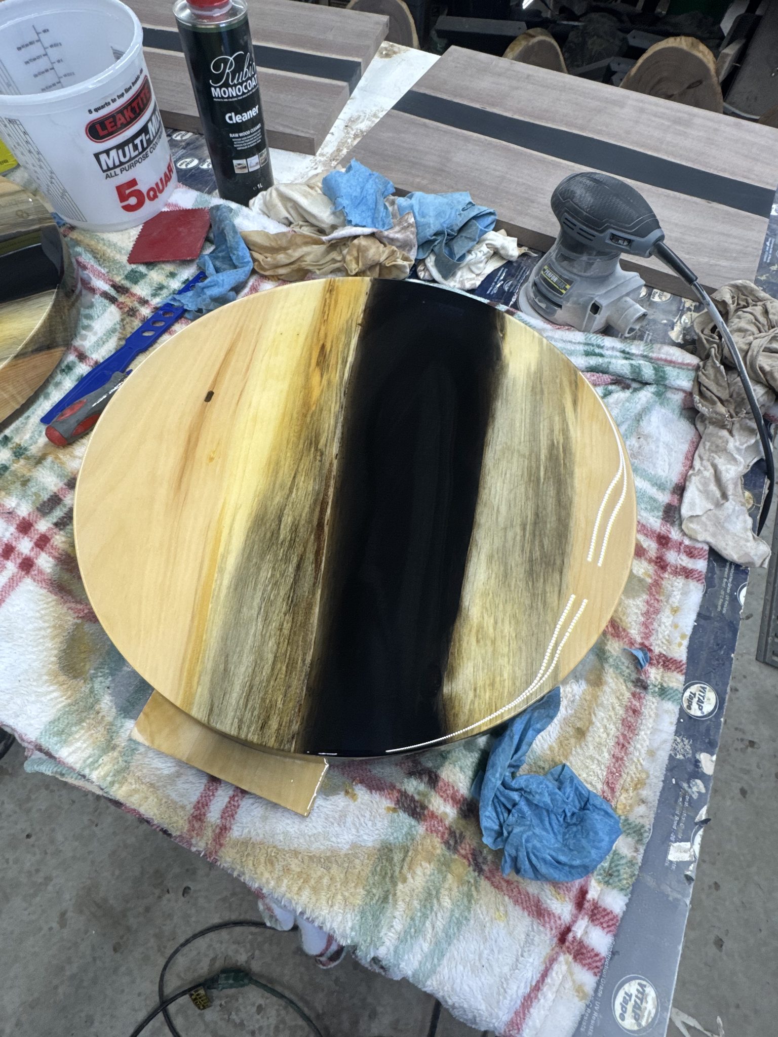Round wood epoxy table with black resin